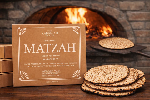Box of Kabbalah Centre Matzah with matzah on a stone surface and oven in the background